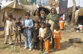 A Pakistani family with their workiing donkey.