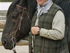Cowboy taking care to keep horse calm before mounting him for a ride.