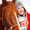 Student in warm clothing engaged with a horse.