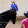 Monty Roberts demonstrating training techniques to a youn girl.