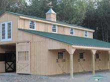 A large Center aisle Horizon Structures barn with overhang.