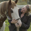 Woman showing a close relationship whith her horse.