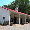 Horizon Structures shedrow barn sited conveniently on horse property.