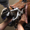 Equine dentist using speculum and power floater to care for horse's teeth.