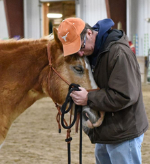 Veteran embracing his therapy horse.