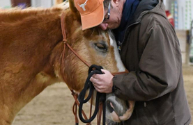 Veteran embracing his assisted therapy horse.
