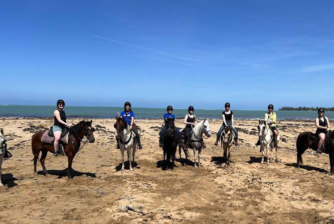 University of Kentucky students riding horses on Luquillo Beach in Puerto Rico.