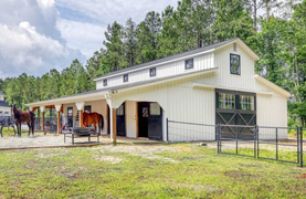 Horizon Structures bardominium with center aisle barn, living spaces upstairs, and attractive architectural treatments on exterior.