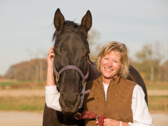 Horse behaviorist getting close to a horse.