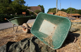 Keeping horse stalls mucked and clean with wheelbarrow and helpful tools.
