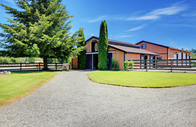 A modern barn that allows room for horses and plenty of storage.
