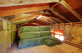 Hay bales stored to preserve quality.