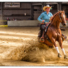 Rider bringing horse to an abrupt stop during a reining competition.