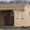 A three-sided wood run-in shed to protect horses during cold winter weather.