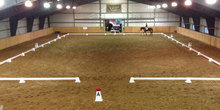Rider and horse in a dressage scrimmage arena.