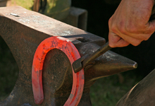 Farrier crafting a custom horse shoe