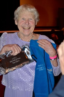 Pat Olivia holding Endurance Hall of Fame awards