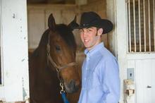 UK student Colton Woods working with horses at UK's Maine Chance Farm