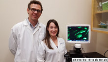 Dr. Koch and PhD candidate Sarah Lepage - microscope with screenshot of MSC cells adhering to plastic