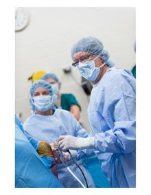 Dr. Wayne McIlwraith  and vet colleagues performing surgery on horse